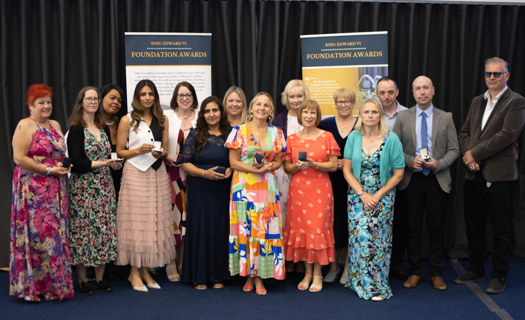 Group of students and faculty at Kevi Foundation event, posing for a photo with awards
