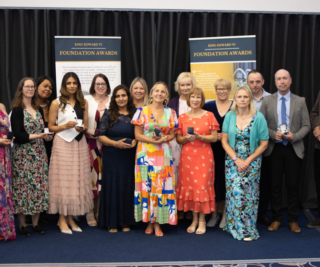 Group of students and faculty at the Kevi Foundation awards ceremony, posing for a photo with certificates.