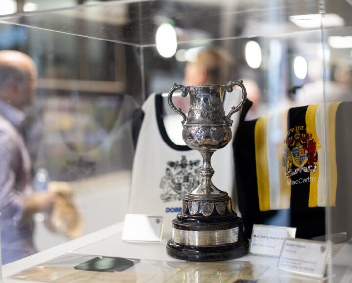 Shiny silver trophy on display in a glass case, symbolizing student achievement and educational excellence