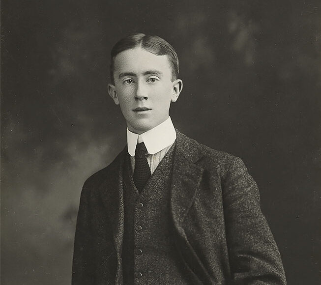 Young man in formal attire, posing for a classic black and white portrait.